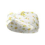 Goldie Floral on Ivory headband featuring small butter yellow flowers, crafted from a buttery-soft, ultra-stretchy poly-knit blend, designed for versatility and comfort.