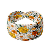 Golden Harvest white headband featuring a orange and gold floral pattern, part of The Jen Hamilton Collection. Designed for comfort and versatility with ultra-stretchy, non-slip fabric.
