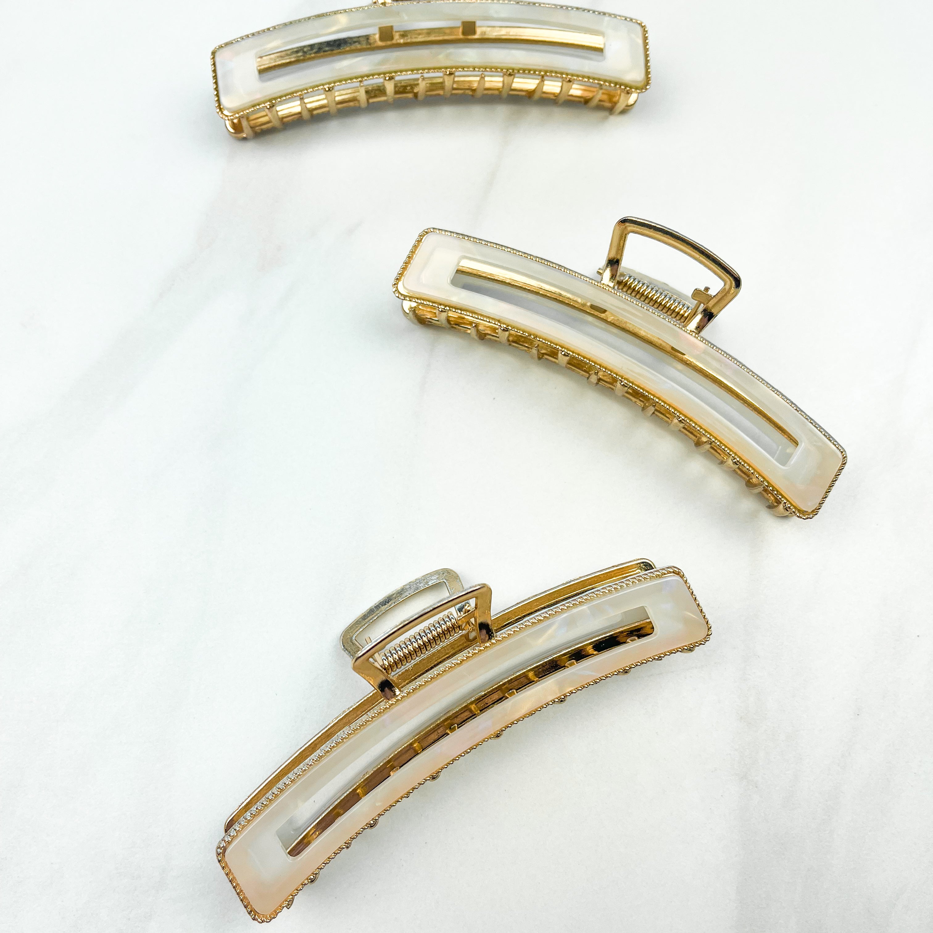 Fly Away Lilac Clip, a 4.5-inch glossy white metal claw clip with hinge closure, shown among similar fashion accessories for versatile styling.