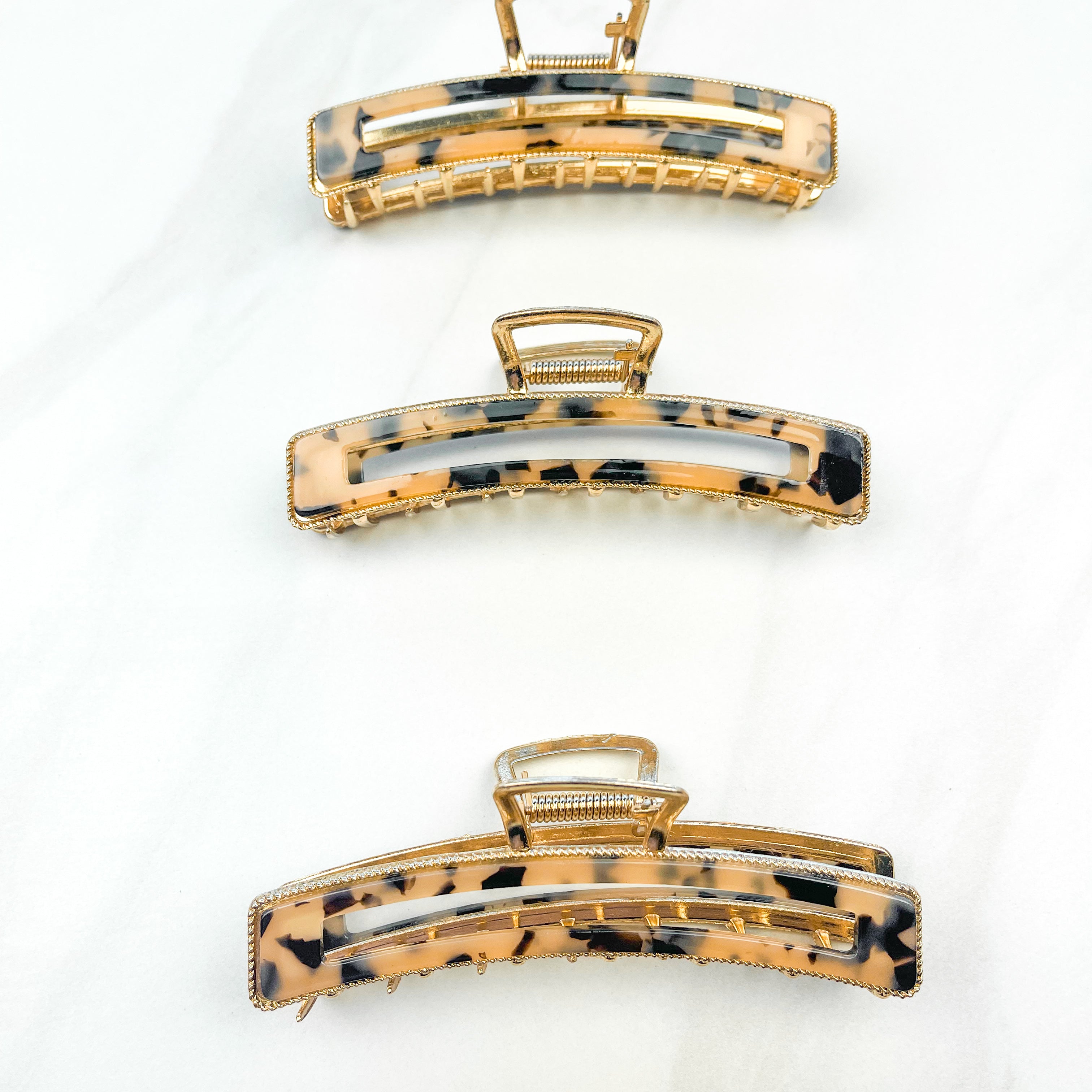 Fly Away Lilac Clip, a 4.5-inch glossy tortoise metal claw clip with hinge closure, shown among similar fashion accessories for versatile styling.