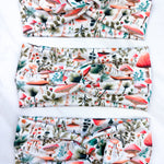 An Enchanted Garden headband with a mushroom and plant pattern, featuring a knot design. Versatile 3-in-1 twist style, sweat-absorbent, non-slip, and machine washable. Functional and stylish for any activity.