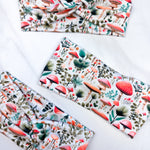 An Enchanted Garden headband with a mushroom and plant pattern, featuring a knot design. Versatile 3-in-1 twist style, sweat-absorbent, non-slip, and machine washable. Functional and stylish for any activity.