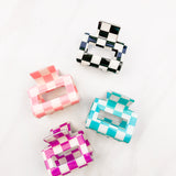 Checking In Lilac Clip: a 2-inch glossy checkered claw clip with a hinge closure, perfect for styling and keeping hair in place.