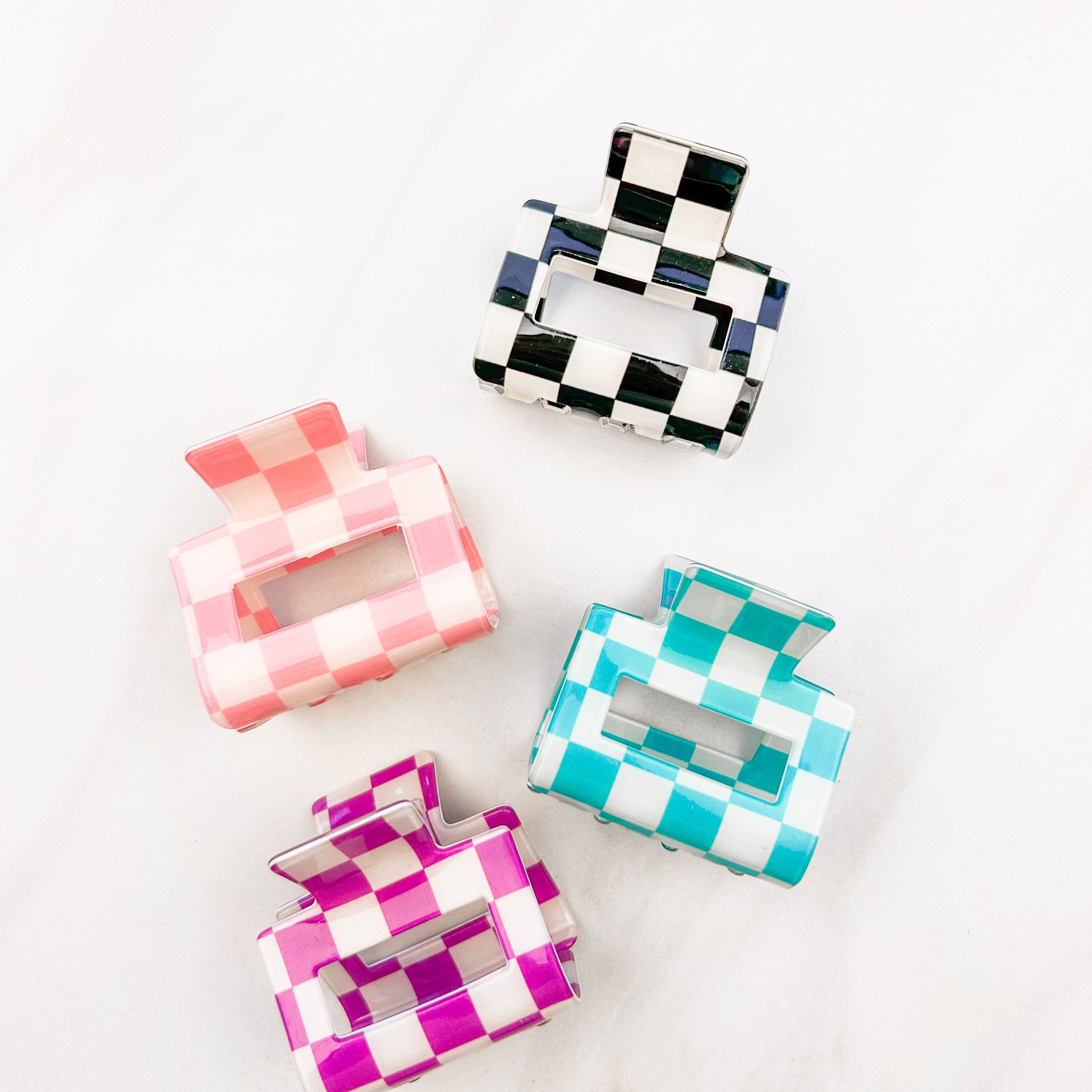 Checking In Lilac Clip: a 2-inch glossy checkered claw clip with a hinge closure, perfect for styling and keeping hair in place.