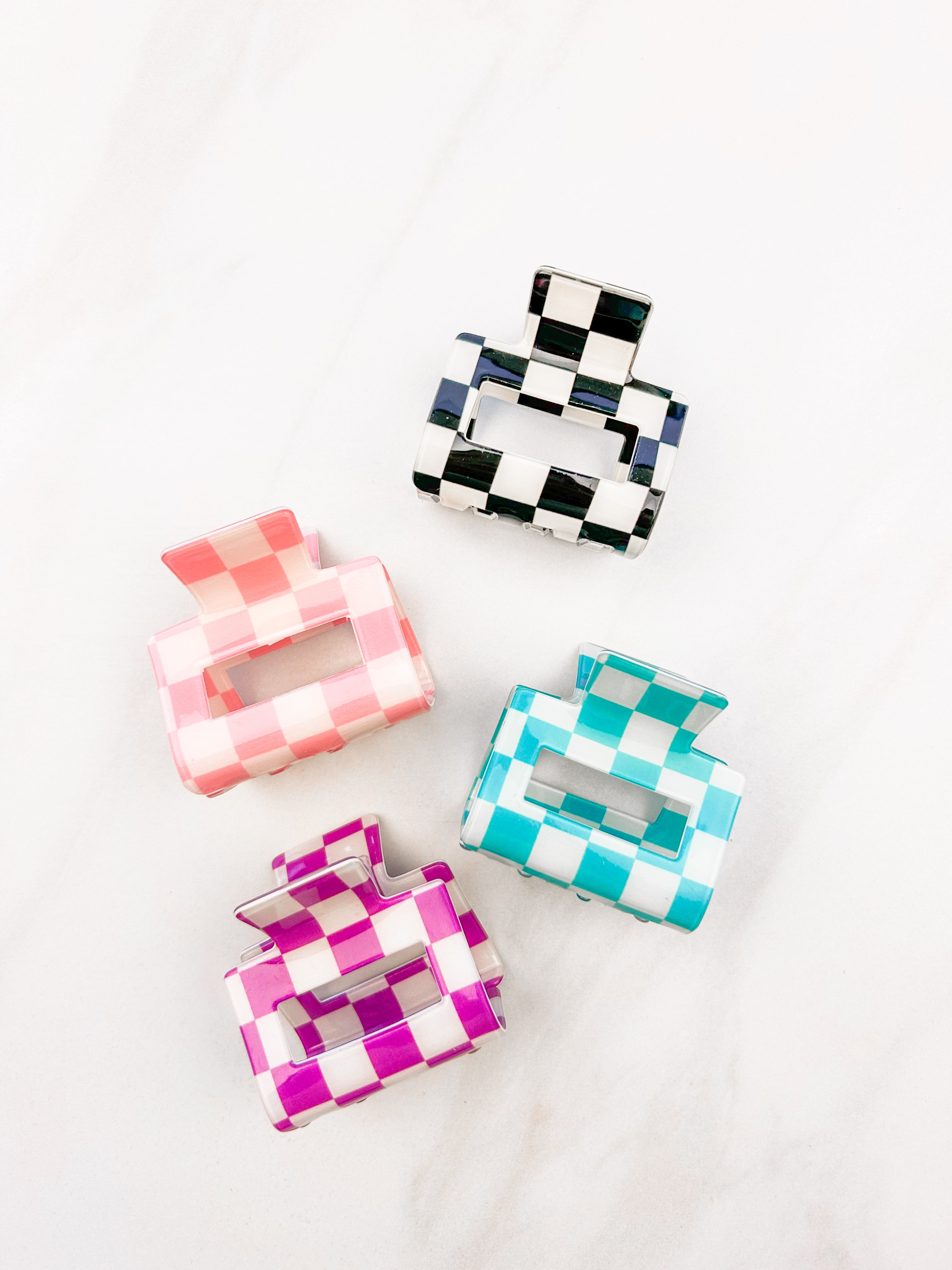 Checking In Lilac Clip: a 2-inch glossy checkered claw clip with a hinge closure, perfect for styling and keeping hair in place.