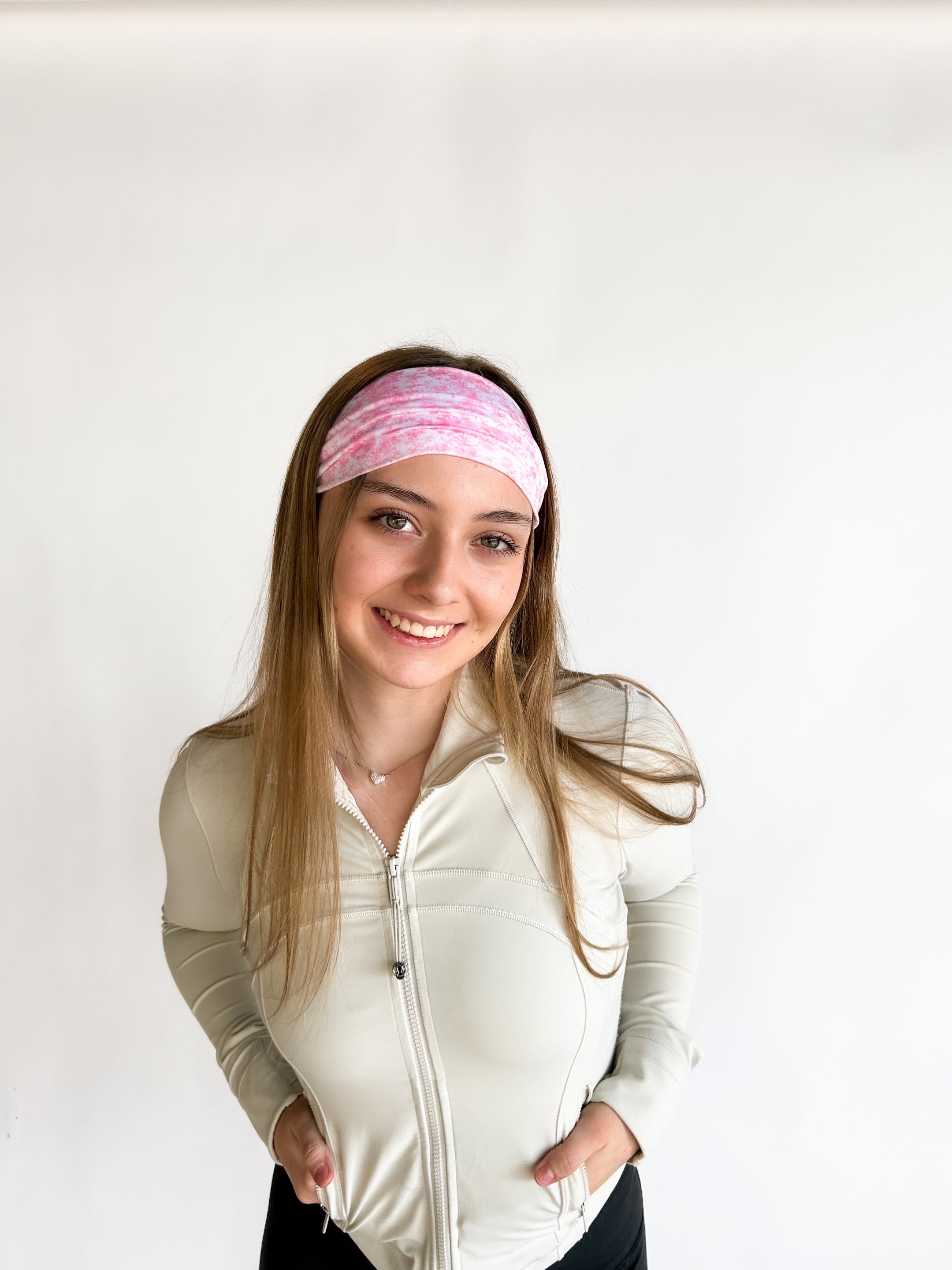 Woman with long hair wearing a Mia Floral on Ivory headband, showcasing its versatile 3-in-1 twist style and non-slip style perfect for workouts.