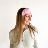 Woman with long hair wearing a Mia Floral on Ivory headband, showcasing its versatile 3-in-1 twist style and non-slip style perfect for workouts.