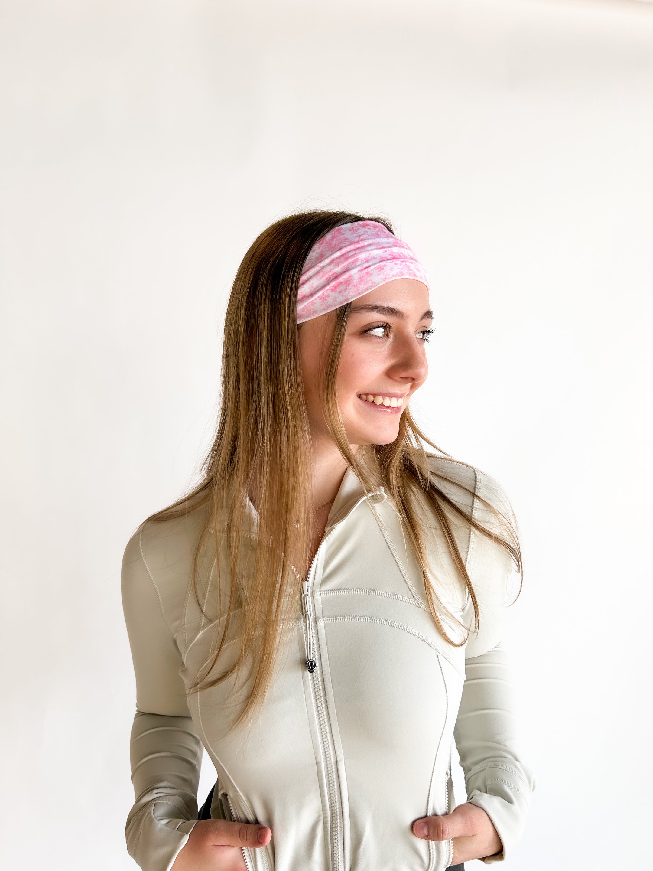 Woman with long hair wearing a Mia Floral on Ivory headband, showcasing its versatile 3-in-1 twist style and non-slip style perfect for workouts.