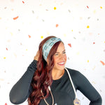 A woman confidently wears the Scrub In headband with a stethoscope, showcasing its versatile 3-in-1 twist style. Designed for function and style, perfect for workouts or workdays.