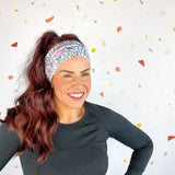A woman confidently wears Lilac Market's Certified Flexpert headband. Functional and stylish, machine washable, ultra-soft poly-knit blend, sweat-absorbent, non-slip, versatile 3-in-1 twist style. Designed in Springfield, MO.