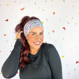 A woman confidently wears Lilac Market's Certified Flexpert headband. Functional and stylish, machine washable, ultra-soft poly-knit blend, sweat-absorbent, non-slip, versatile 3-in-1 twist style. Designed in Springfield, MO.