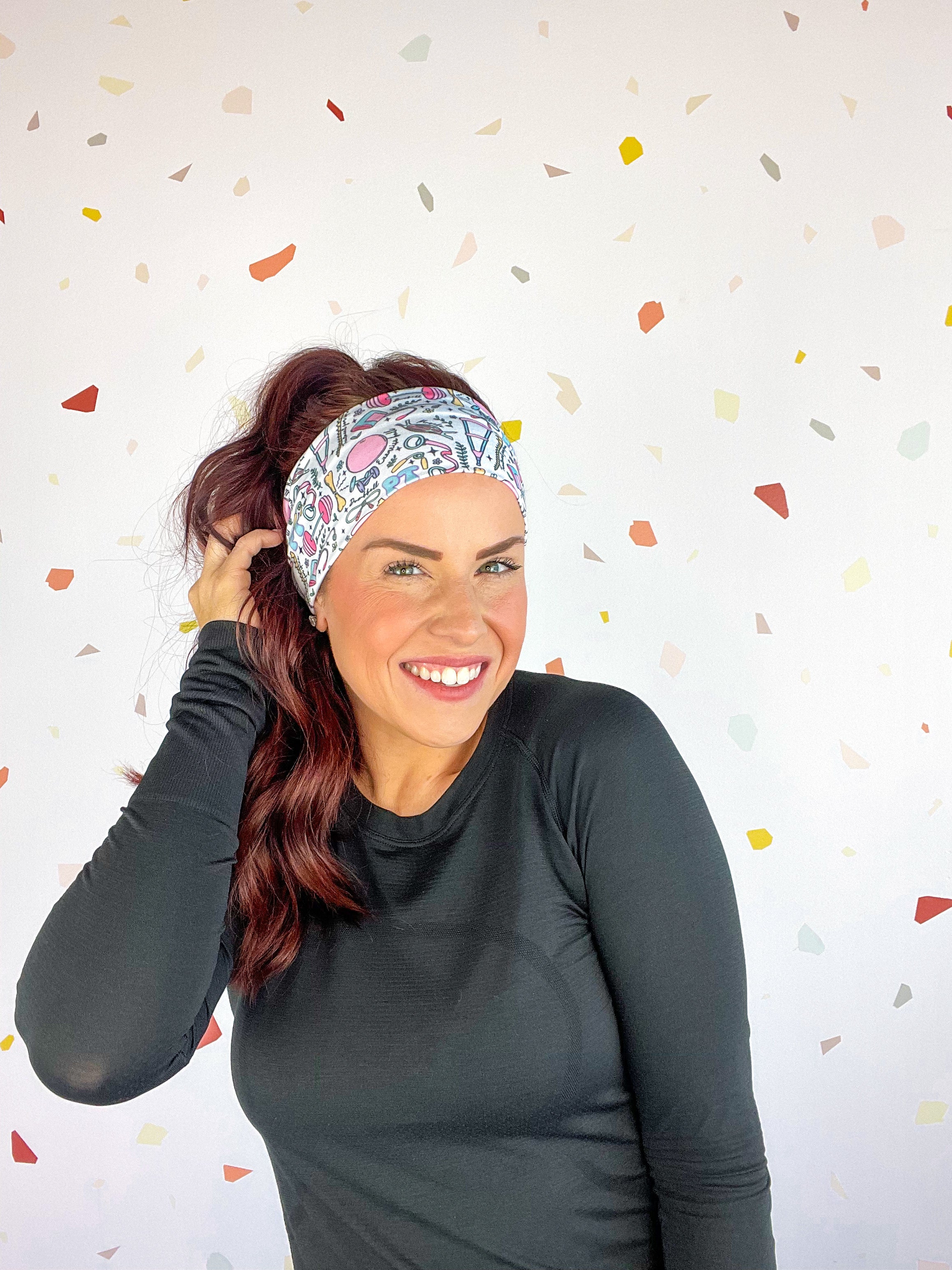 A woman confidently wears Lilac Market's Certified Flexpert headband. Functional and stylish, machine washable, ultra-soft poly-knit blend, sweat-absorbent, non-slip, versatile 3-in-1 twist style. Designed in Springfield, MO.