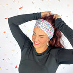 A woman confidently wears Lilac Market's Certified Flexpert headband. Functional and stylish, machine washable, ultra-soft poly-knit blend, sweat-absorbent, non-slip, versatile 3-in-1 twist style. Designed in Springfield, MO.