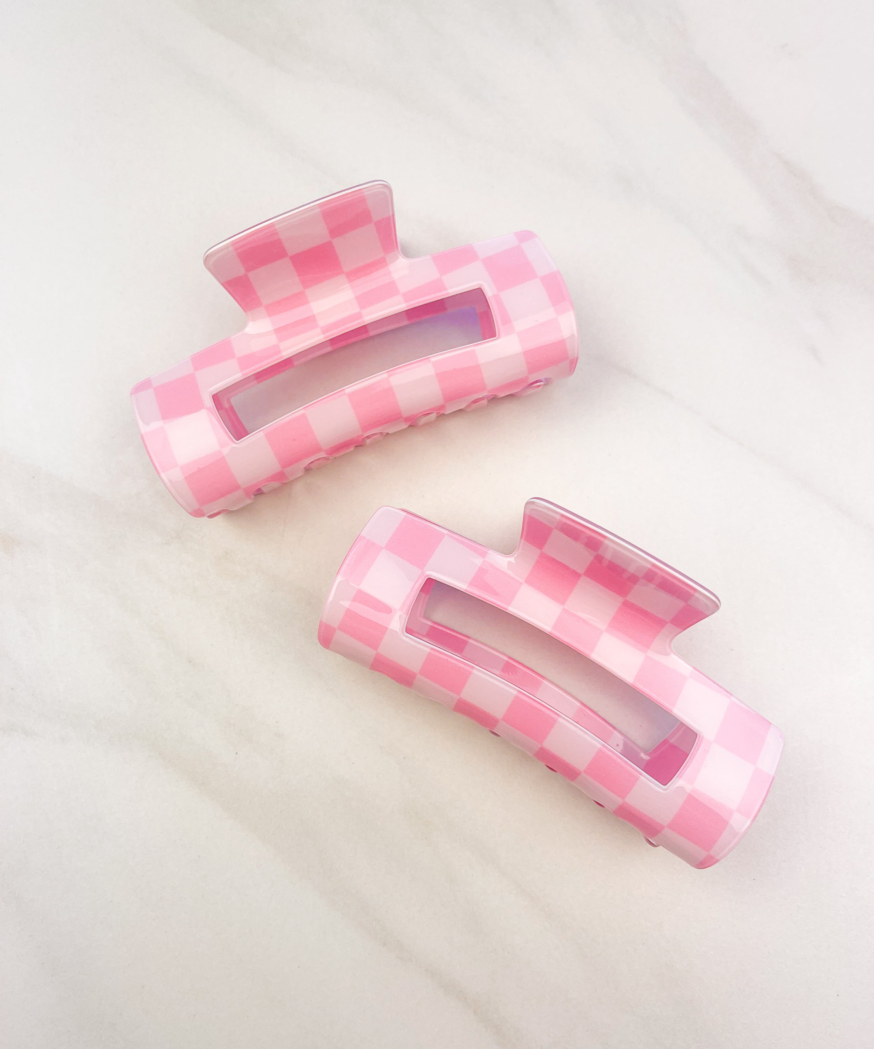 Checkmate Lilac Clip: a 3.6-inch glossy pink checkered claw clip with a hinge closure, perfect for styling and keeping hair in place.