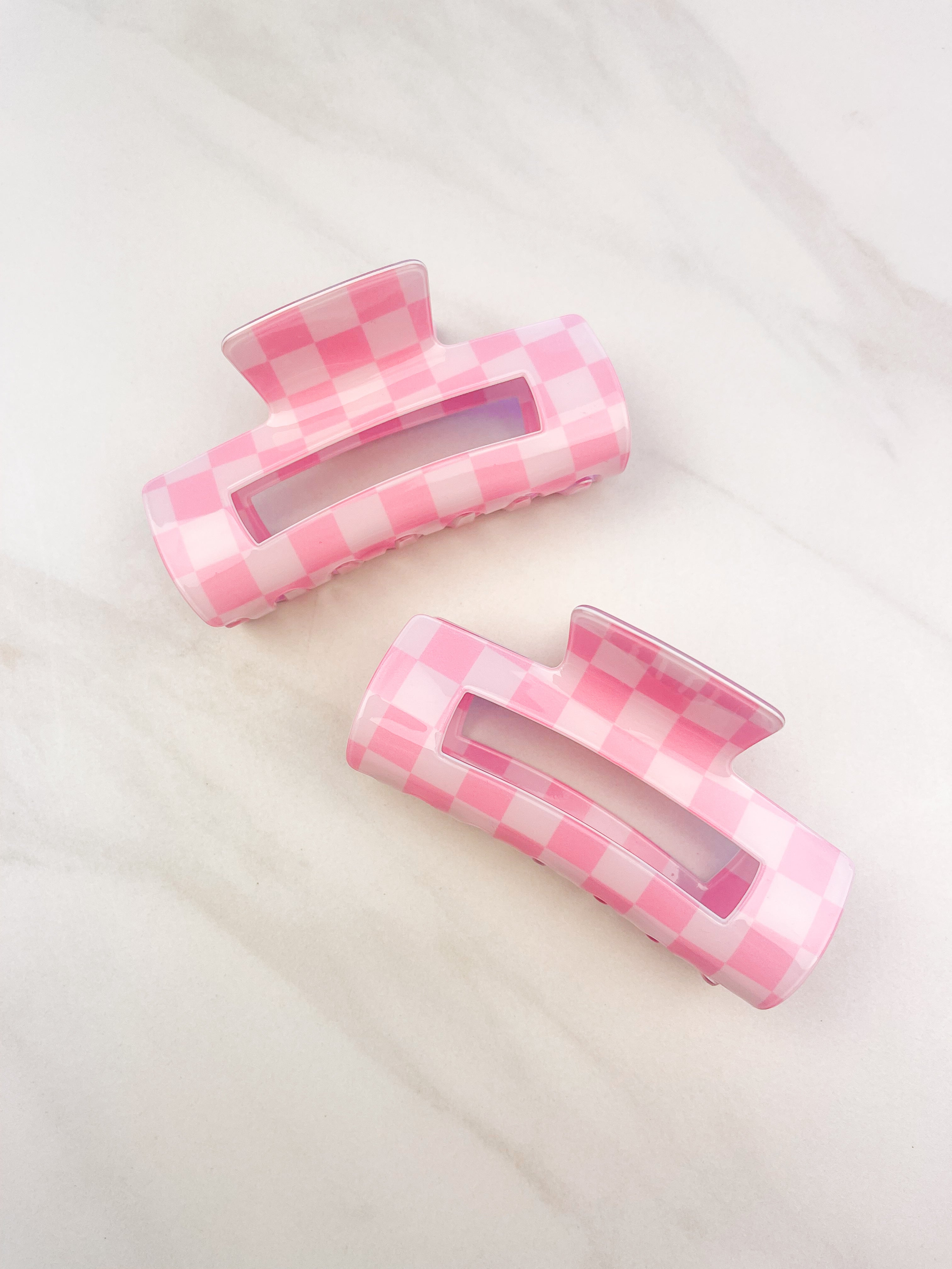 Checkmate Lilac Clip: a 3.6-inch glossy pink checkered claw clip with a hinge closure, perfect for styling and keeping hair in place.