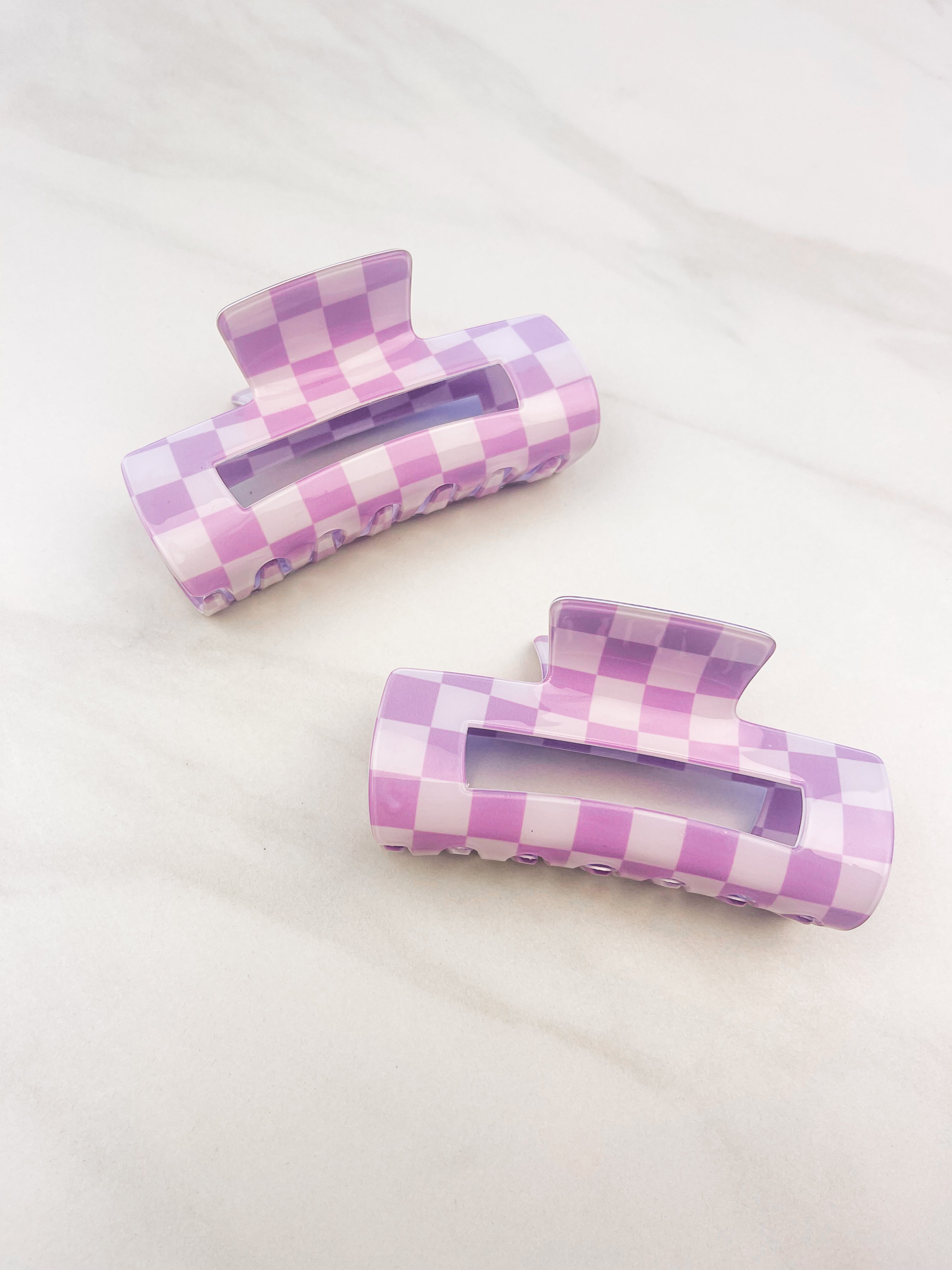 Checkmate Lilac Clip: a 3.6-inch glossy purple checkered claw clip with a hinge closure, perfect for styling and keeping hair in place.