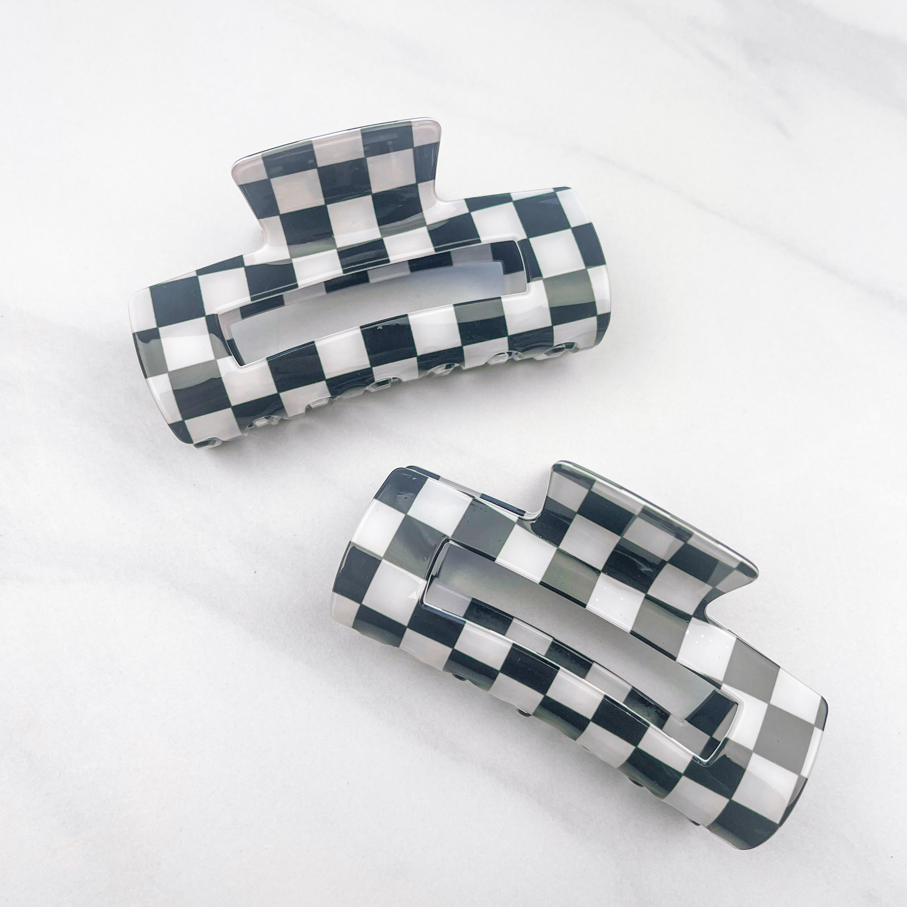 Checkmate Lilac Clip: a 3.6-inch glossy black checkered claw clip with a hinge closure, perfect for styling and keeping hair in place.
