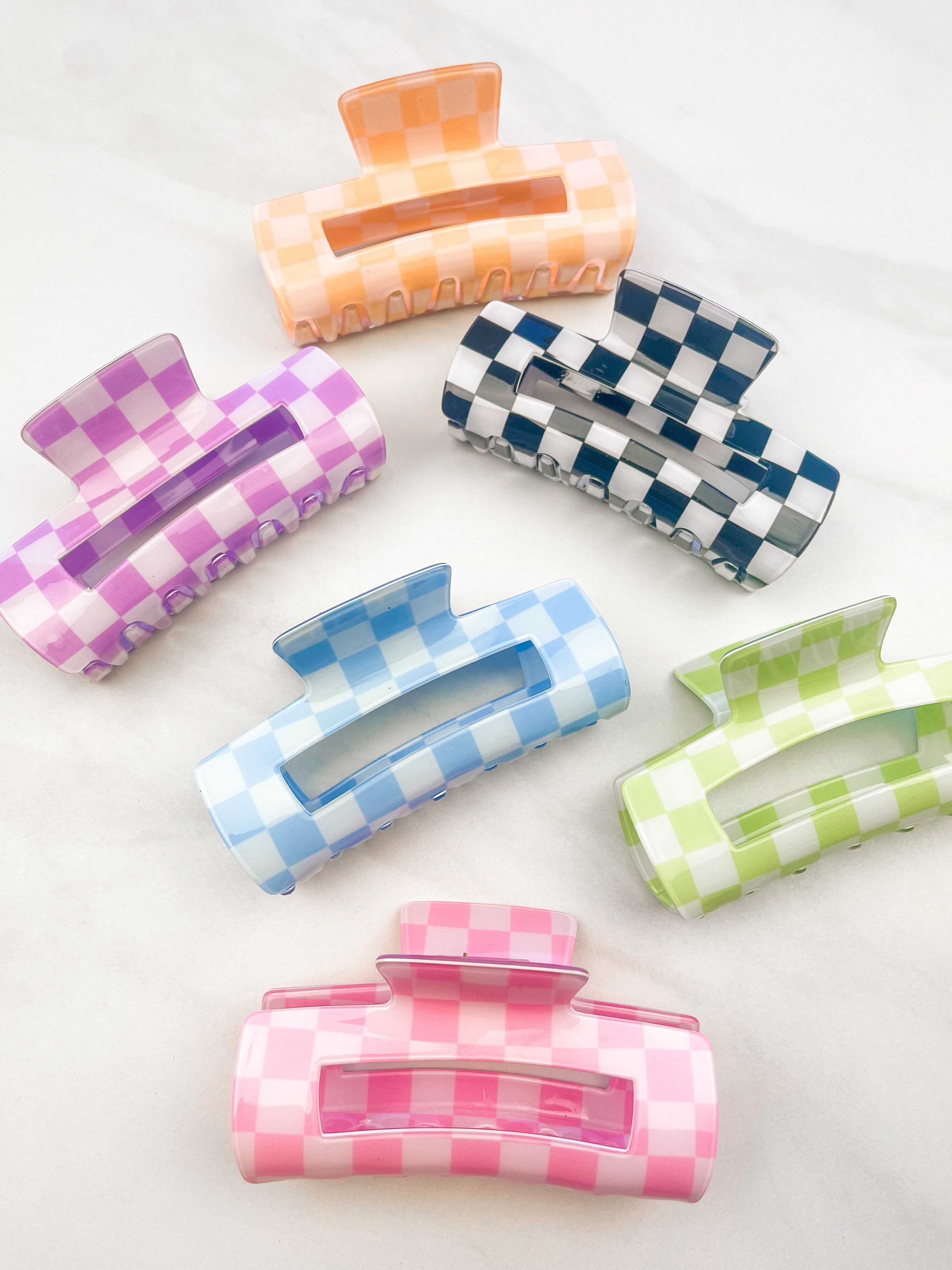 Checkmate Lilac Clip: a 3.6-inch glossy checkered claw clip with a hinge closure, perfect for styling and keeping hair in place.