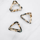 A group of black tortoise Endless Weekend Lilac Clips, triangle-shaped hair accessory, perfect for all hair types. Glossy finish, 1.9 inches long, hinge closure.