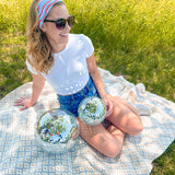 A woman confidently wears a Courtesy of Red, White and Blue headband outdoors, featuring a versatile 3-in-1 twist style for various looks. Designed for comfort and functionality, perfect for workouts or long shifts.