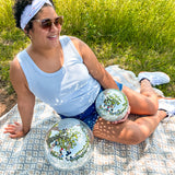 A woman confidently wears the Oh My Stars headband, showcasing its versatile twist style and sweat-absorbent fabric. Designed for function and style, perfect for workouts or play days.