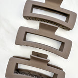 A close-up of the mocha XL Essential Lilac Clip, a 4.8-inch matte hair accessory with a hinge closure. Perfect for all hair types.