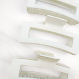 A close-up of the white XL Essential Lilac Clip, a 4.8-inch matte hair accessory with a hinge closure. Perfect for all hair types.