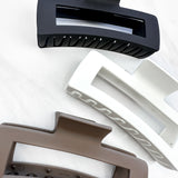 A close-up of a group of XL Essential Lilac Clips, a 4.8-inch matte hair accessory with a hinge closure. Perfect for all hair types.