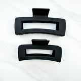 A close-up of the black XL Essential Lilac Clip, a 4.8-inch matte hair accessory with a hinge closure. Perfect for all hair types.