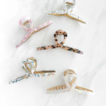 Hair claw clip in marbled white, clear, pink, multi or tortoise in a loop shape