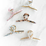 Hair claw clip in marbled white, clear, pink, multi or tortoise in a loop shape