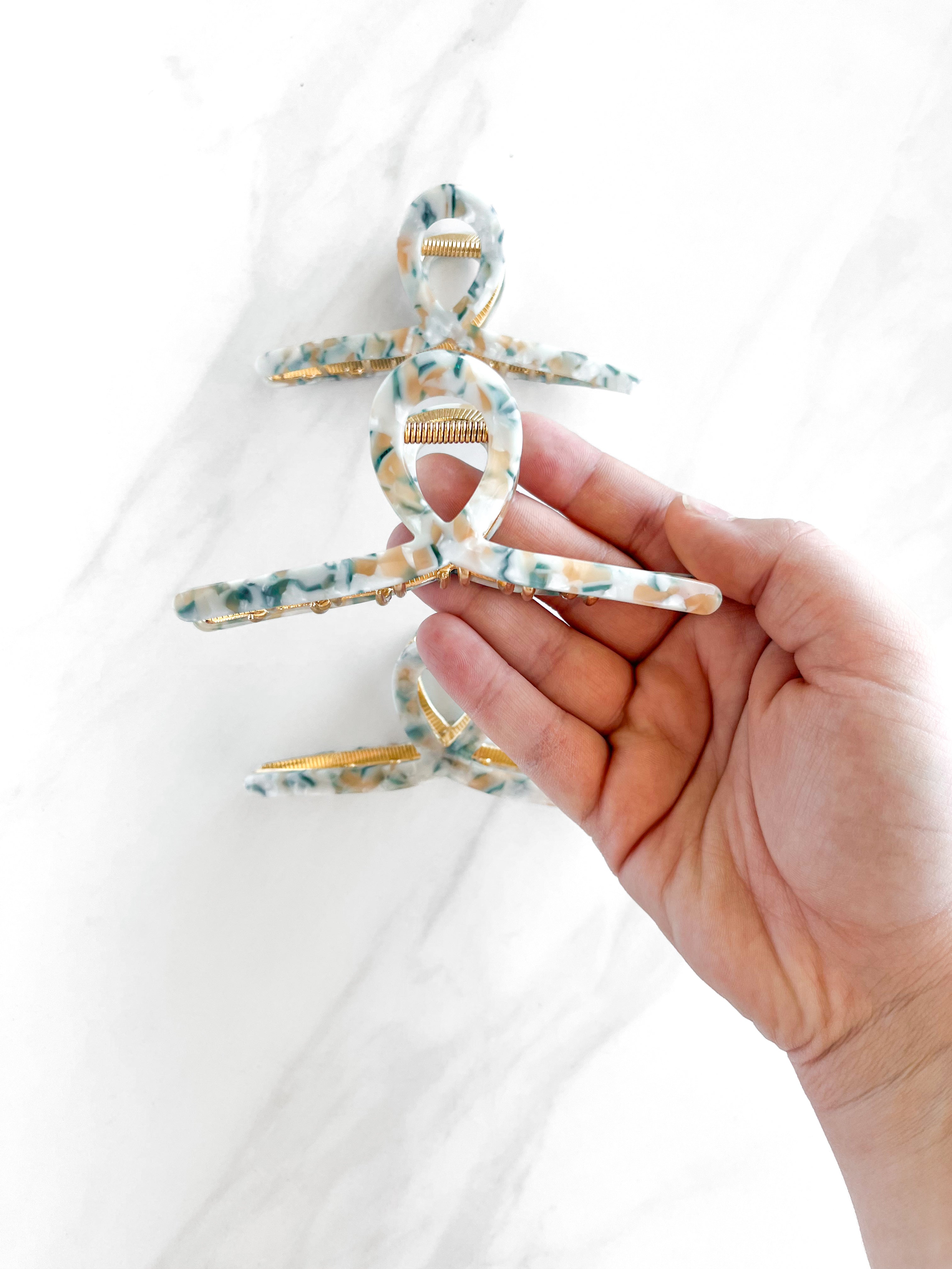 Hair claw clip in marbled white, clear, pink, multi or tortoise in a loop shape