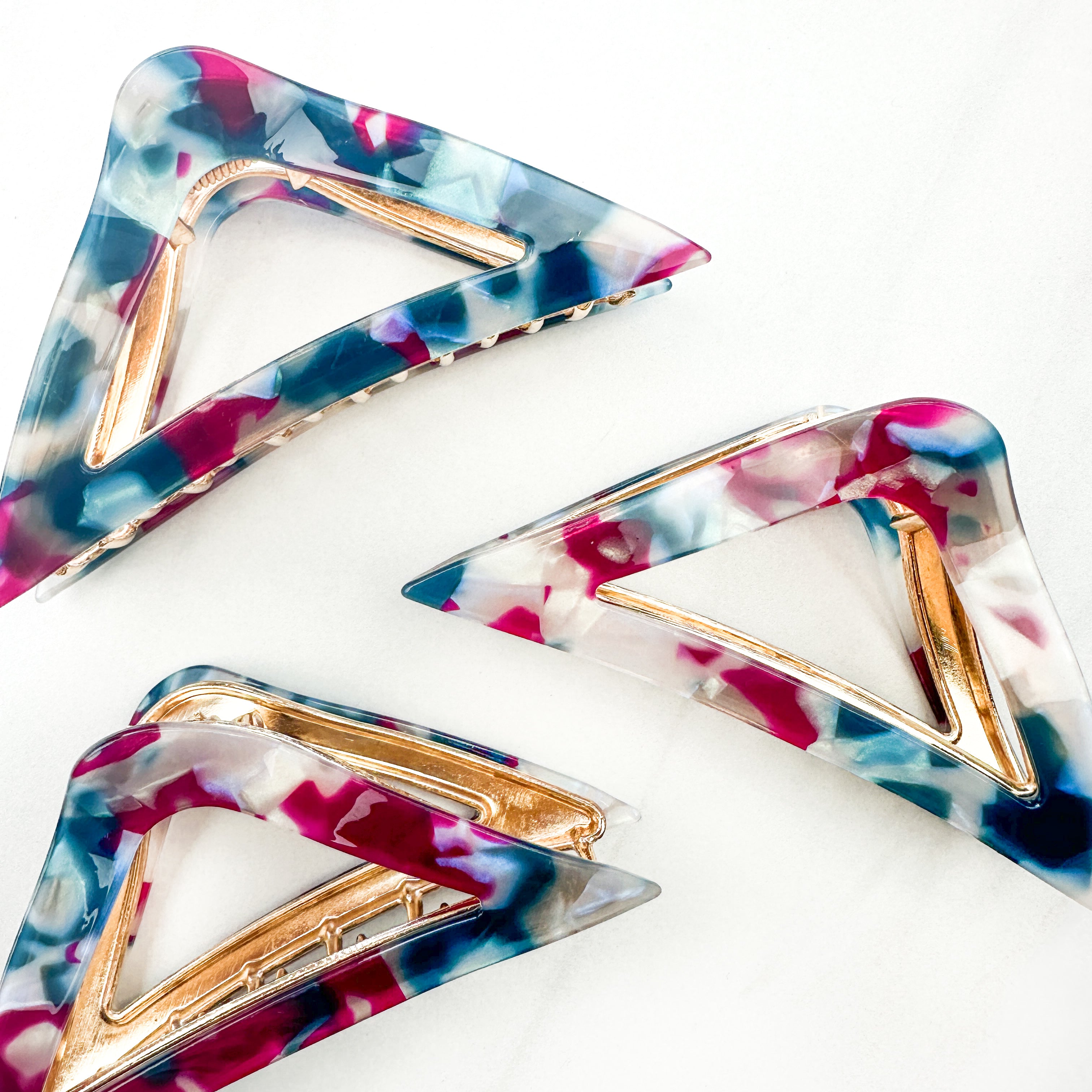 A Different Angle Lilac Clip, a group of blue, pink and white hair clips, perfect for all hair types and textures. 4.5 inches long with a glossy material and hinge closure. Hair-out-of-face approved.