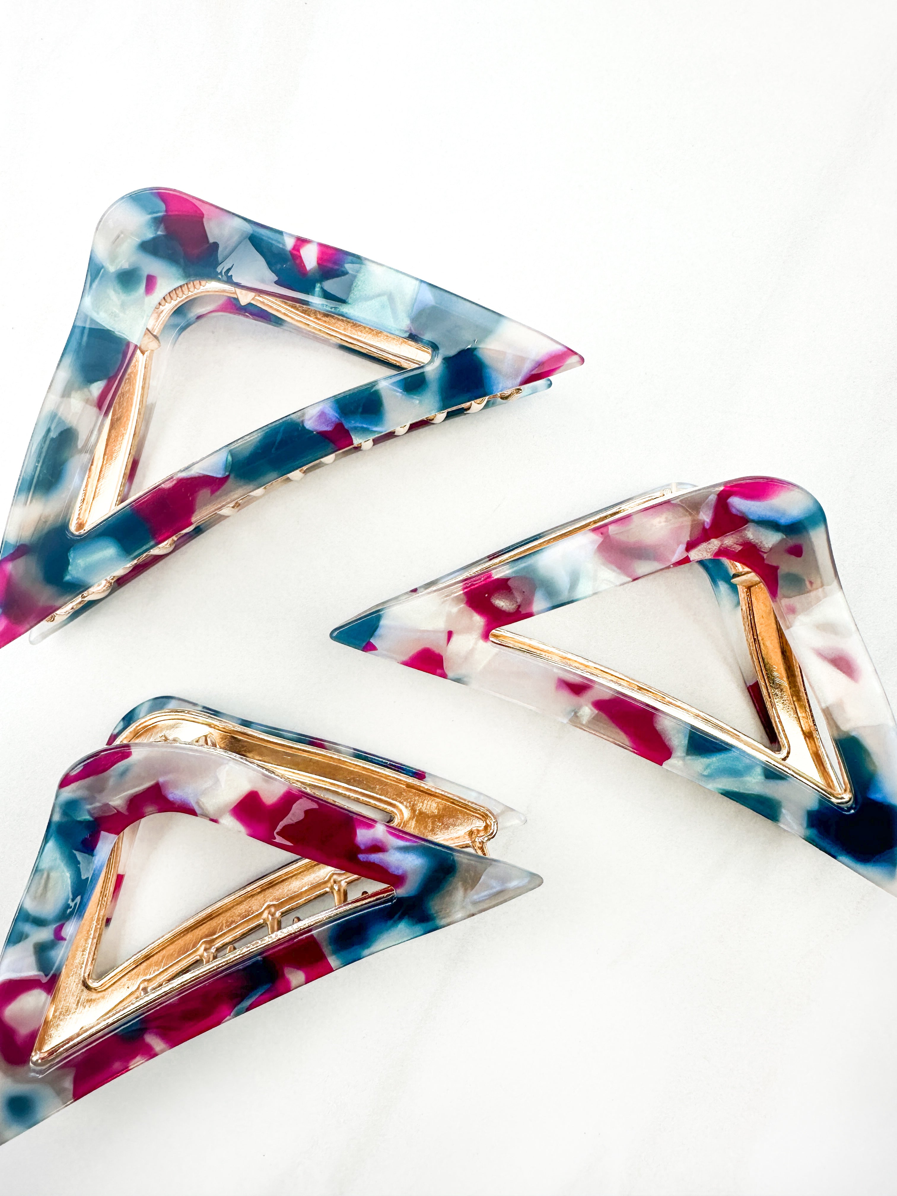 A Different Angle Lilac Clip, a group of blue, pink and white hair clips, perfect for all hair types and textures. 4.5 inches long with a glossy material and hinge closure. Hair-out-of-face approved.