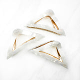 A Different Angle Lilac Clip, a group of white hair clips, perfect for all hair types and textures. 4.5 inches long with a glossy material and hinge closure. Hair-out-of-face approved.