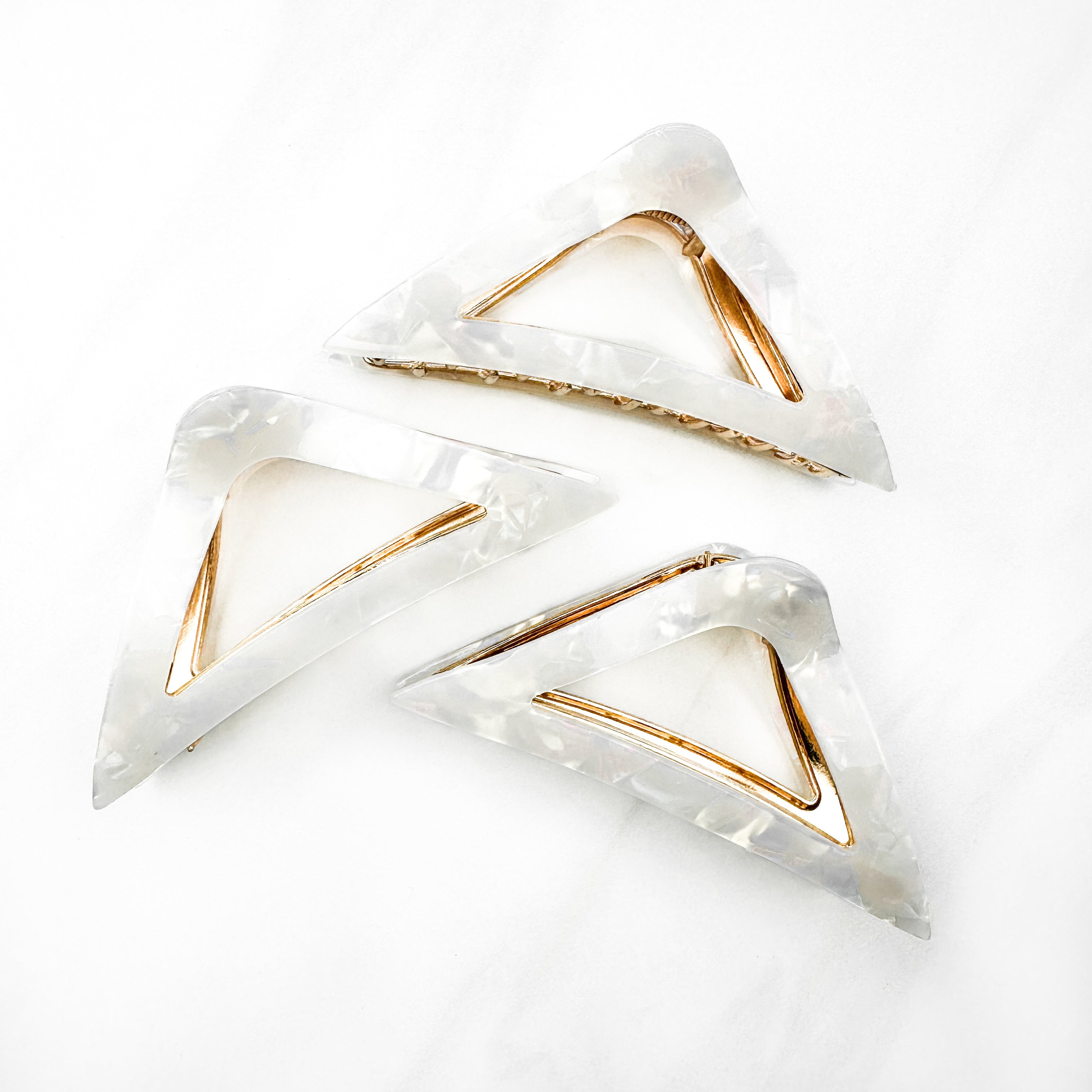 A Different Angle Lilac Clip, a group of white hair clips, perfect for all hair types and textures. 4.5 inches long with a glossy material and hinge closure. Hair-out-of-face approved.