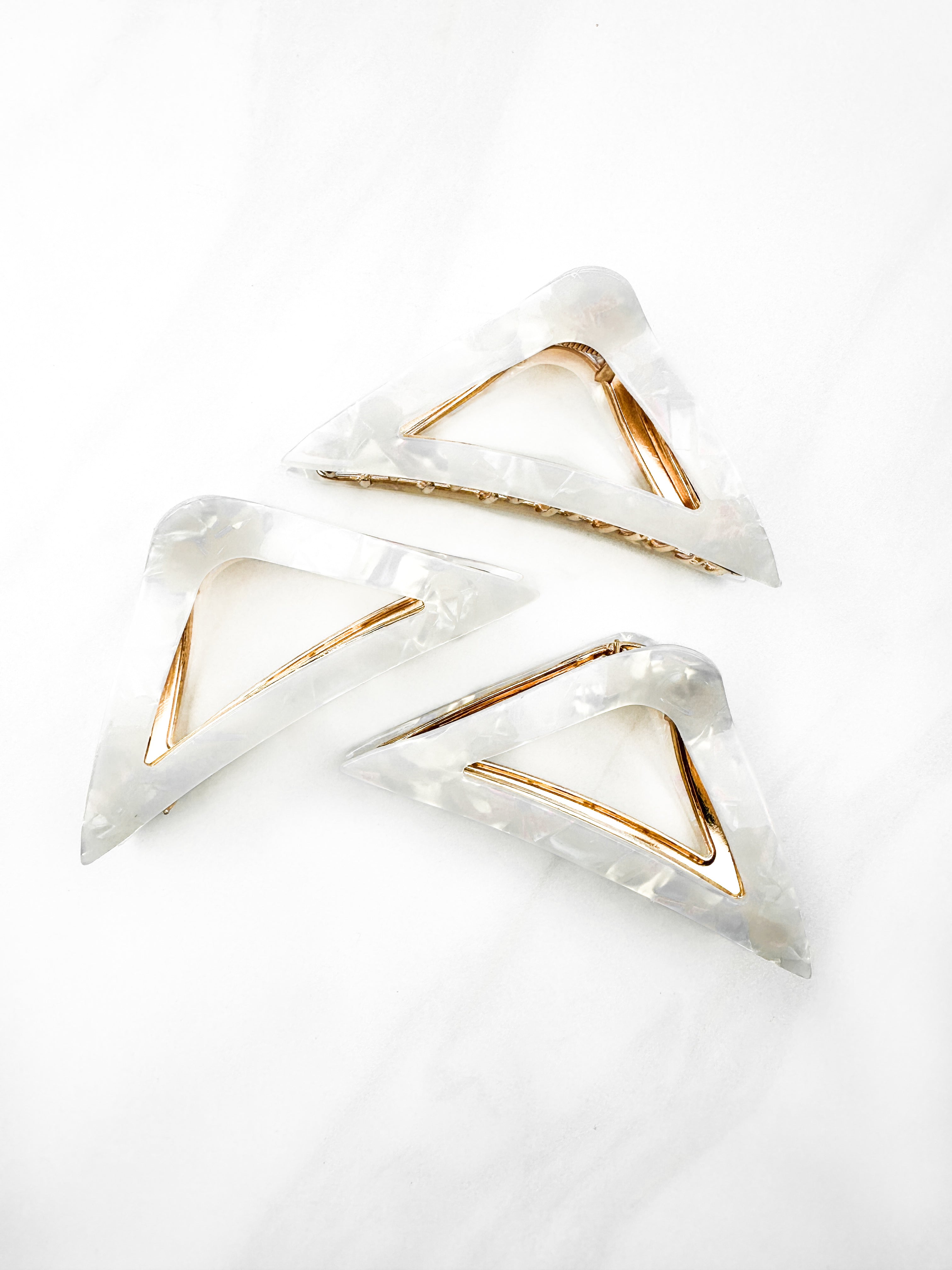 A Different Angle Lilac Clip, a group of white hair clips, perfect for all hair types and textures. 4.5 inches long with a glossy material and hinge closure. Hair-out-of-face approved.