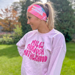 Adult women's acid wash watercolor in hot pink, orange, blue and yellow with the white 70's bubble font saying "Mother Runner".