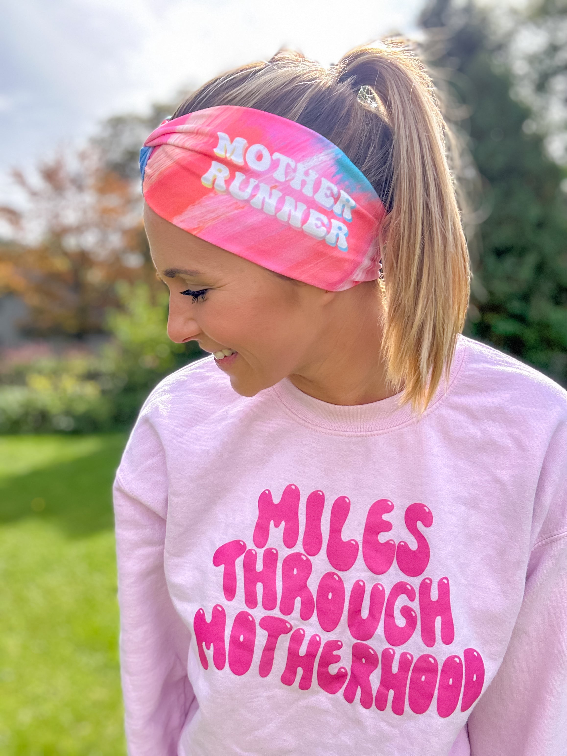 Adult women's acid wash watercolor in hot pink, orange, blue and yellow with the white 70's bubble font saying "Mother Runner".