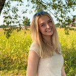 Woman confidently wearing the Long Live Cowgirls headband, showcasing its versatile, non-slip, and ultra-stretchy design ideal for various activities.