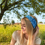 Woman confidently wearing the Long Live Cowgirls headband, showcasing its versatile, non-slip, and ultra-stretchy design ideal for various activities.