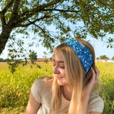 Woman confidently wearing the Long Live Cowgirls headband, showcasing its versatile, non-slip, and ultra-stretchy design ideal for various activities.
