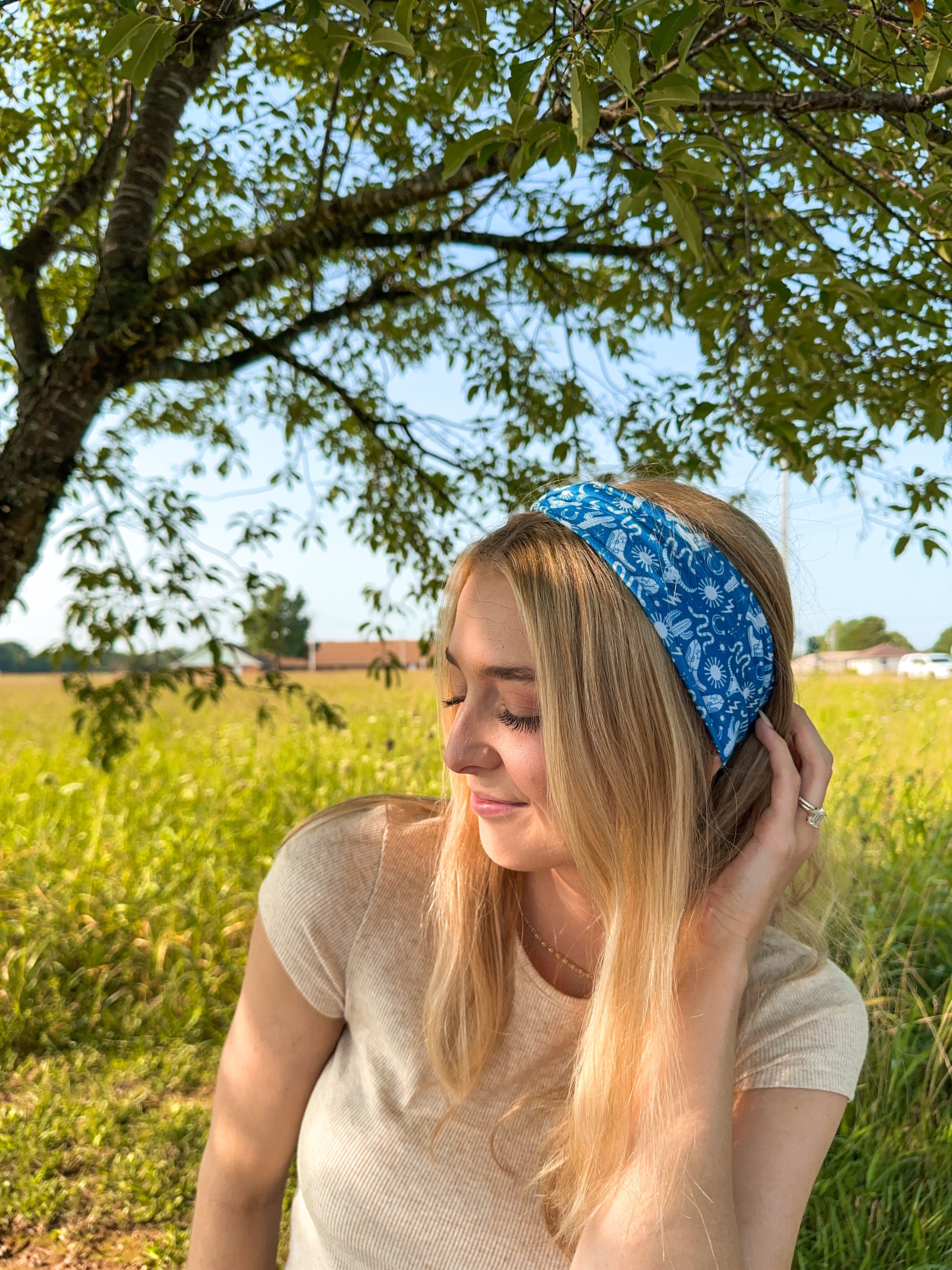 Woman confidently wearing the Long Live Cowgirls headband, showcasing its versatile, non-slip, and ultra-stretchy design ideal for various activities.