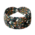 Adult women's black headband with artistic black and white skunk and teal, gold, pink and white allover flowers