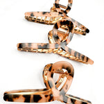 Hair claw clip in marbled white, clear, pink, multi or tortoise in a loop shape