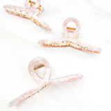 Hair claw clip in marbled white, clear, pink, multi or tortoise in a loop shape