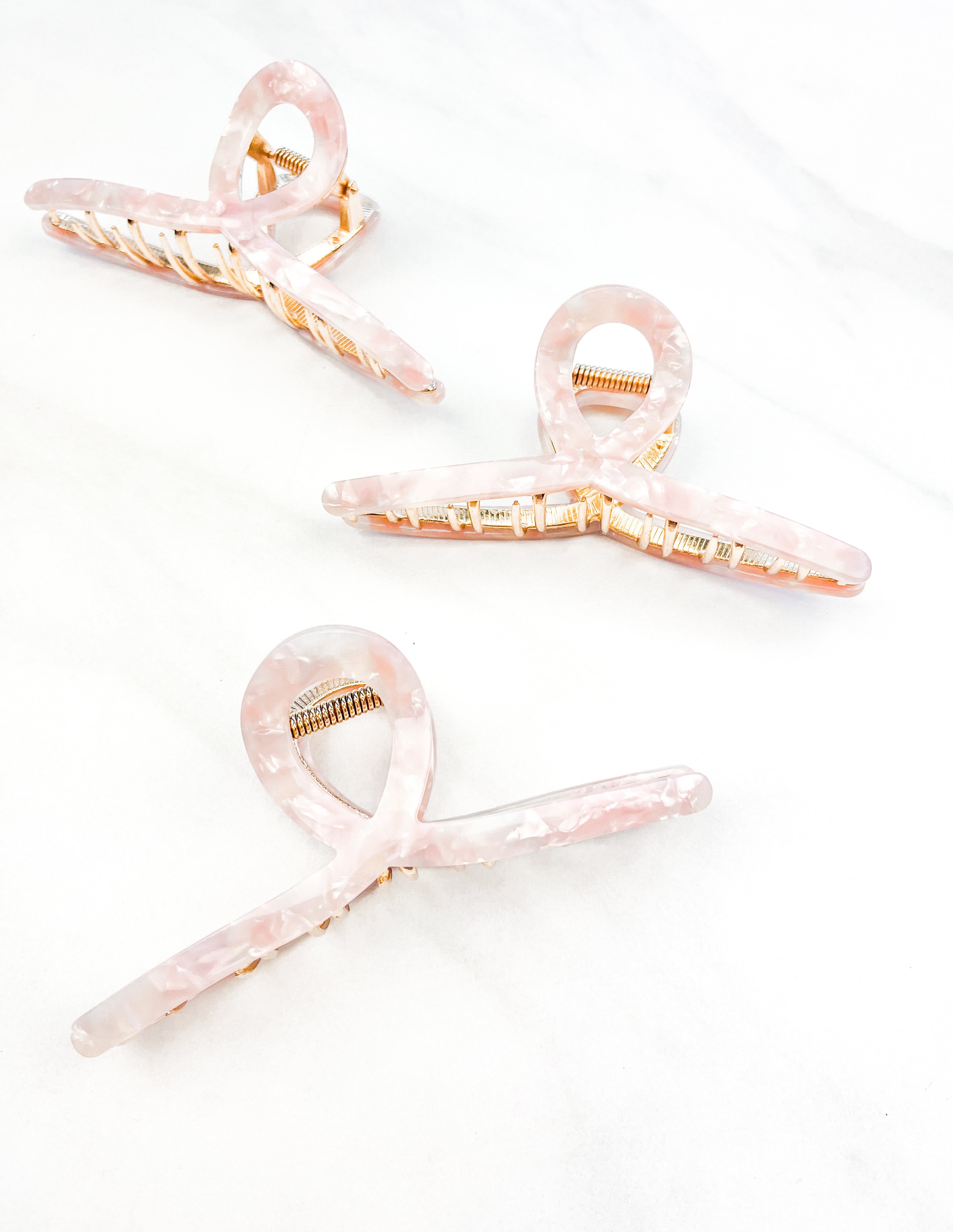 Hair claw clip in marbled white, clear, pink, multi or tortoise in a loop shape