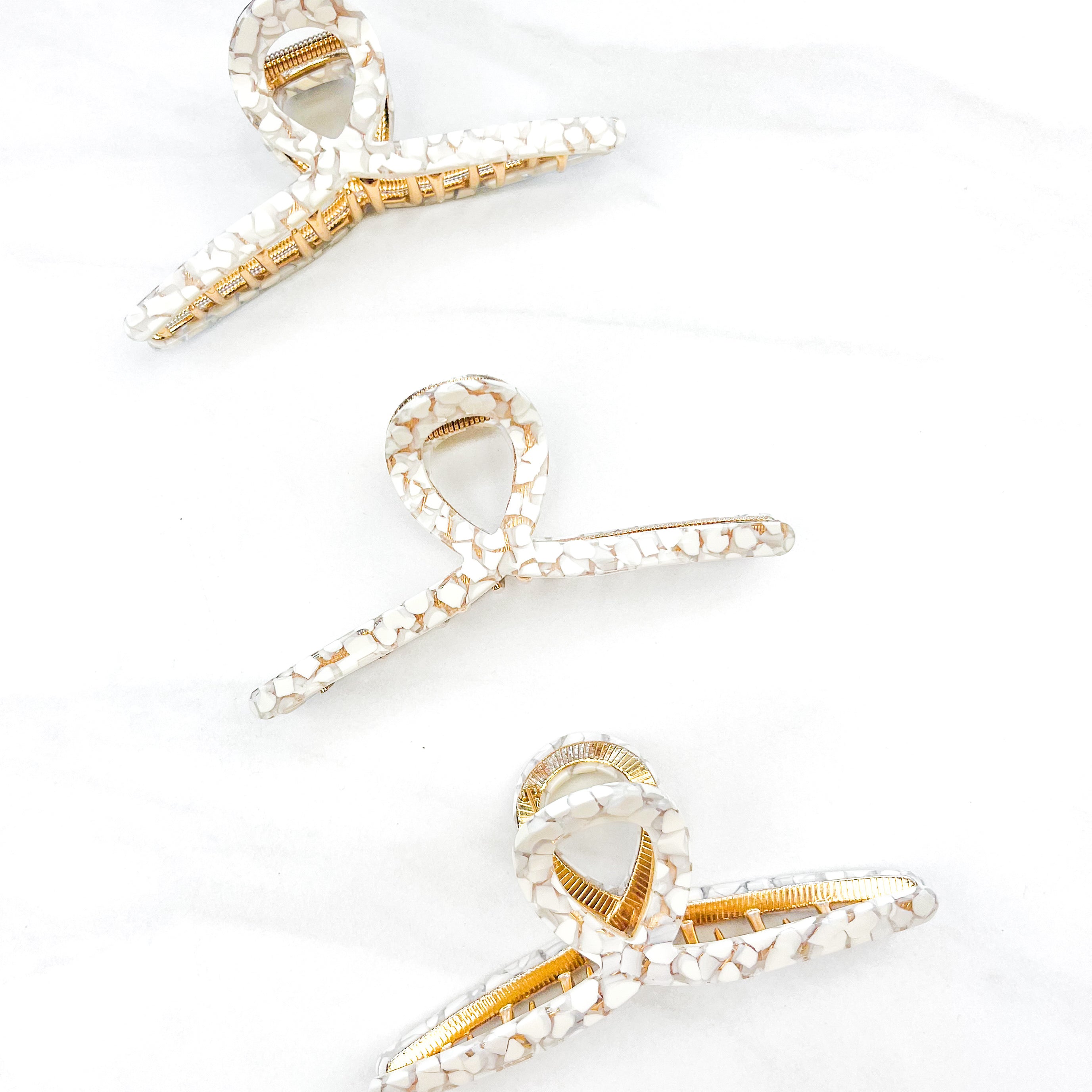 Hair claw clip in marbled white, clear, pink, multi or tortoise in a loop shape