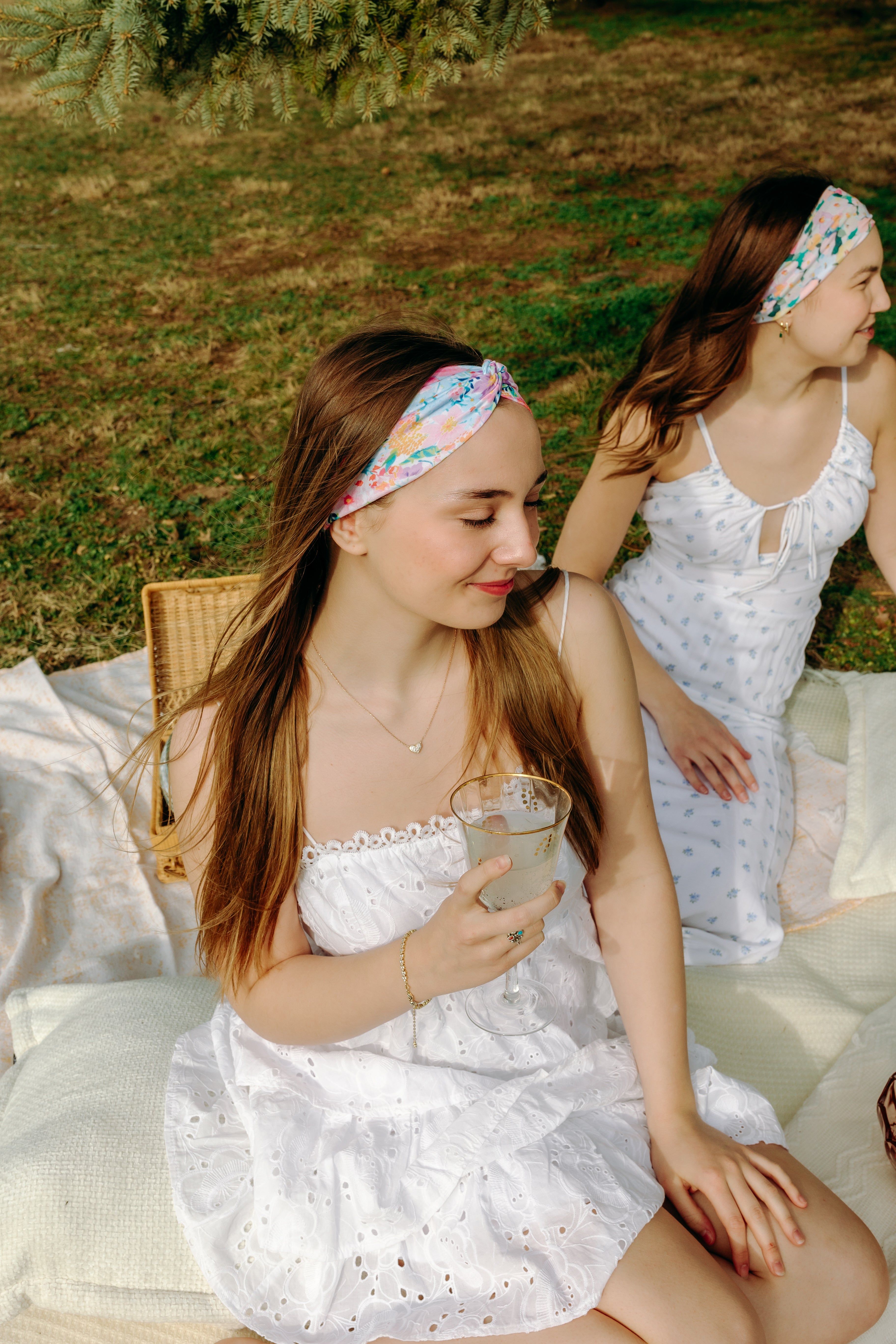 Woman smiling while wearing the Erica Floral on Ivory headband, the perfect non-slip accessory for work or workouts.