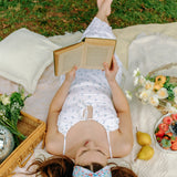 Woman smiling and confidently wearing the Zoey Floral on Sky Blue headband, the perfect non-slip accessory for long shifts or play days.